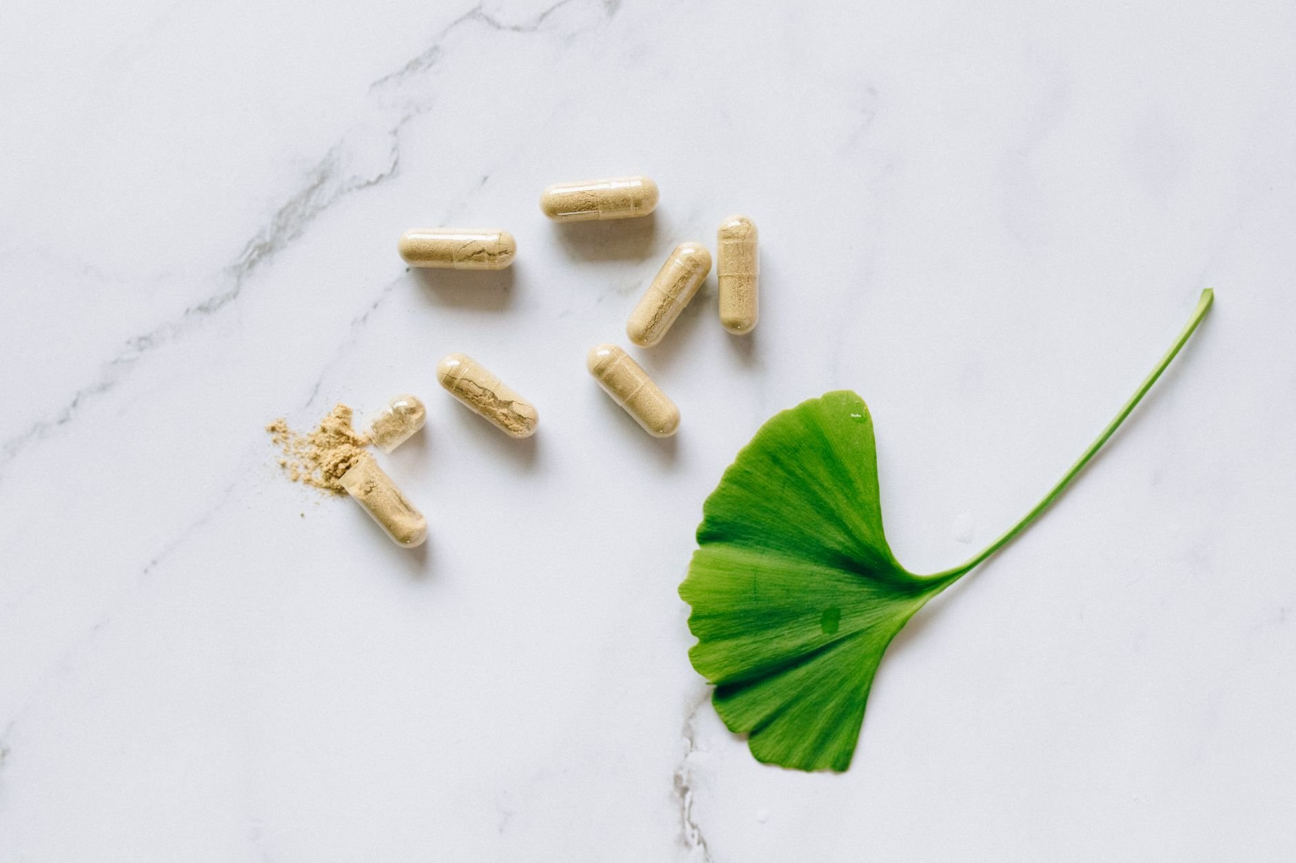 Premium collagen supplement capsules on marble surface in golden light